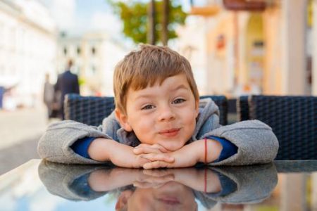 Emotional,Boy,At,A,Table,In,A,Cafe.,Cute,Little